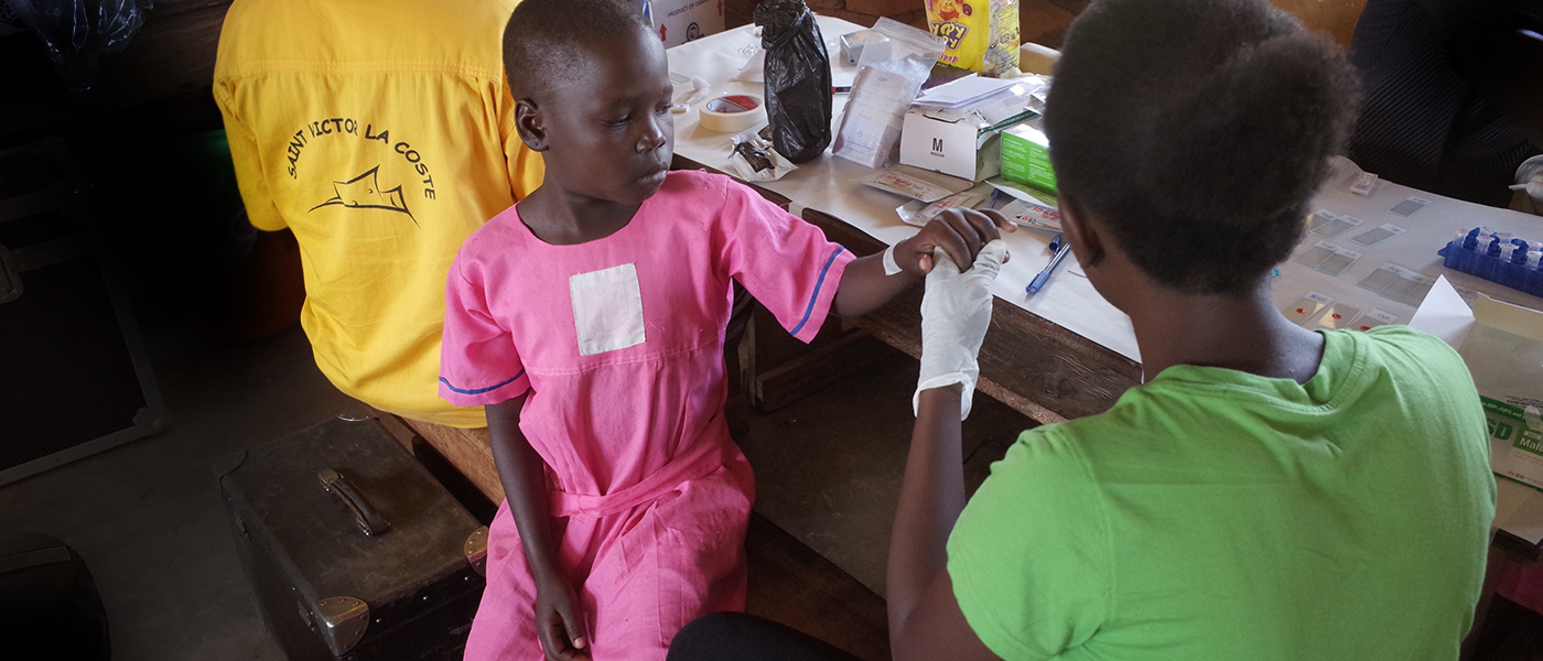 Finger prick blood test at a Ugandan clinic