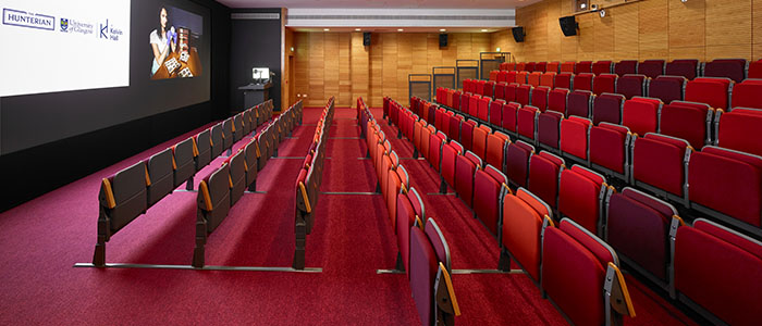Photograph of a lecture theatre inside Kelvin Hall. There is a screen on the wall and seats facing the screen. 